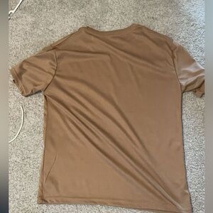 Brown T-shirt praising Jesus.